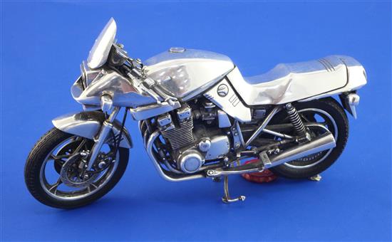 An unmarked 1980s? silver miniature model of a Suzuki Katana motorbike, length 7.25in.